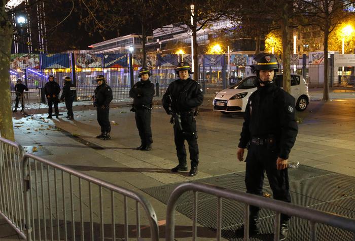Police officers secure the  Stade de France stadium during the international friendly soccer France against Germany, Friday, Nov. 13, 2015 in Saint Denis, outside Paris. Two police officials say at least 11 people have been killed in shootouts and other violence around Paris. Police have reported shootouts in at least two restaurants in Paris. At least two explosions have been heard near the Stade de France stadium, and French media is reporting of a hostage-taking in the capital. (ANSA/AP Photo/Michel Euler)